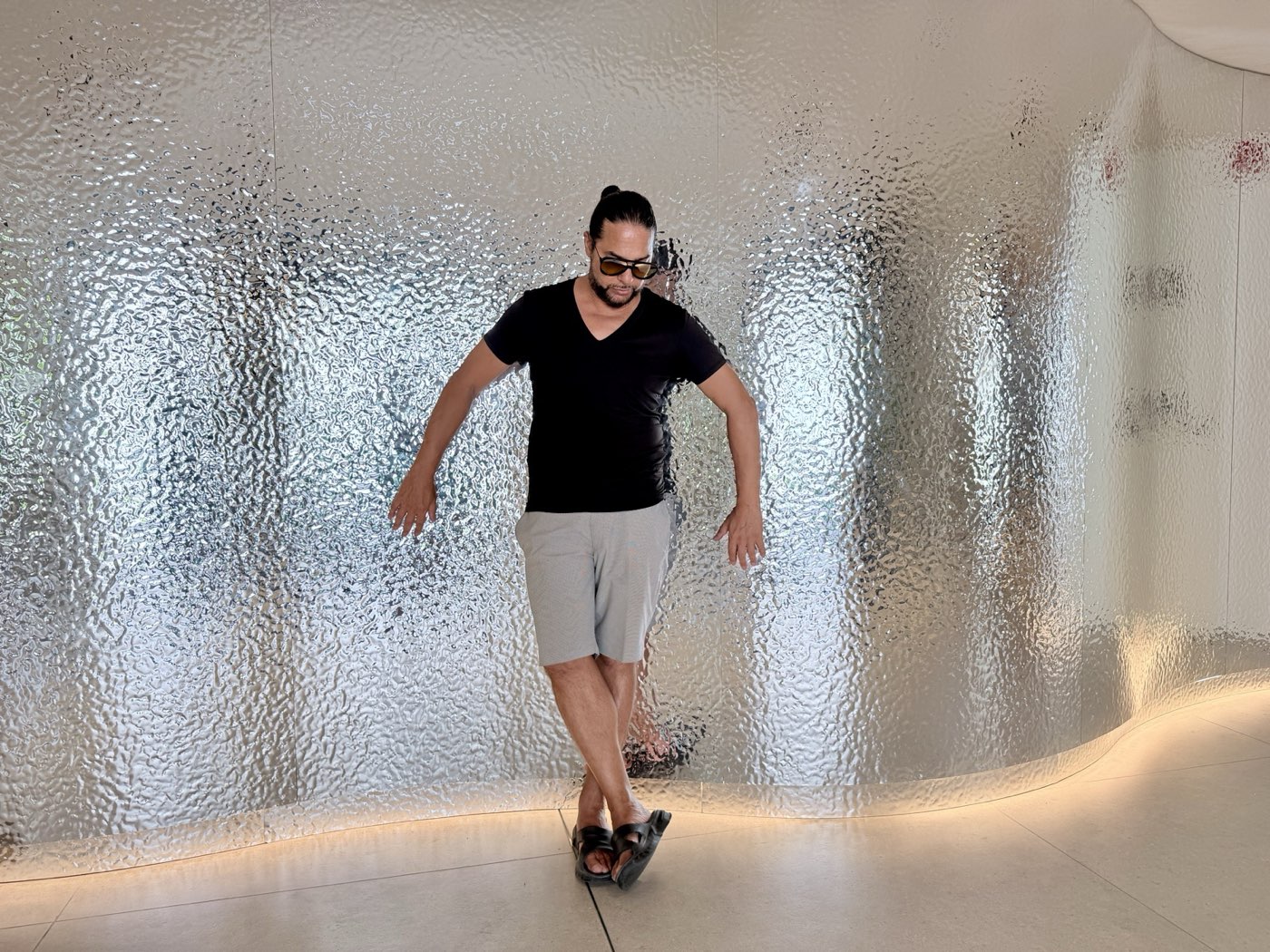 A dance step against the textured glass wall