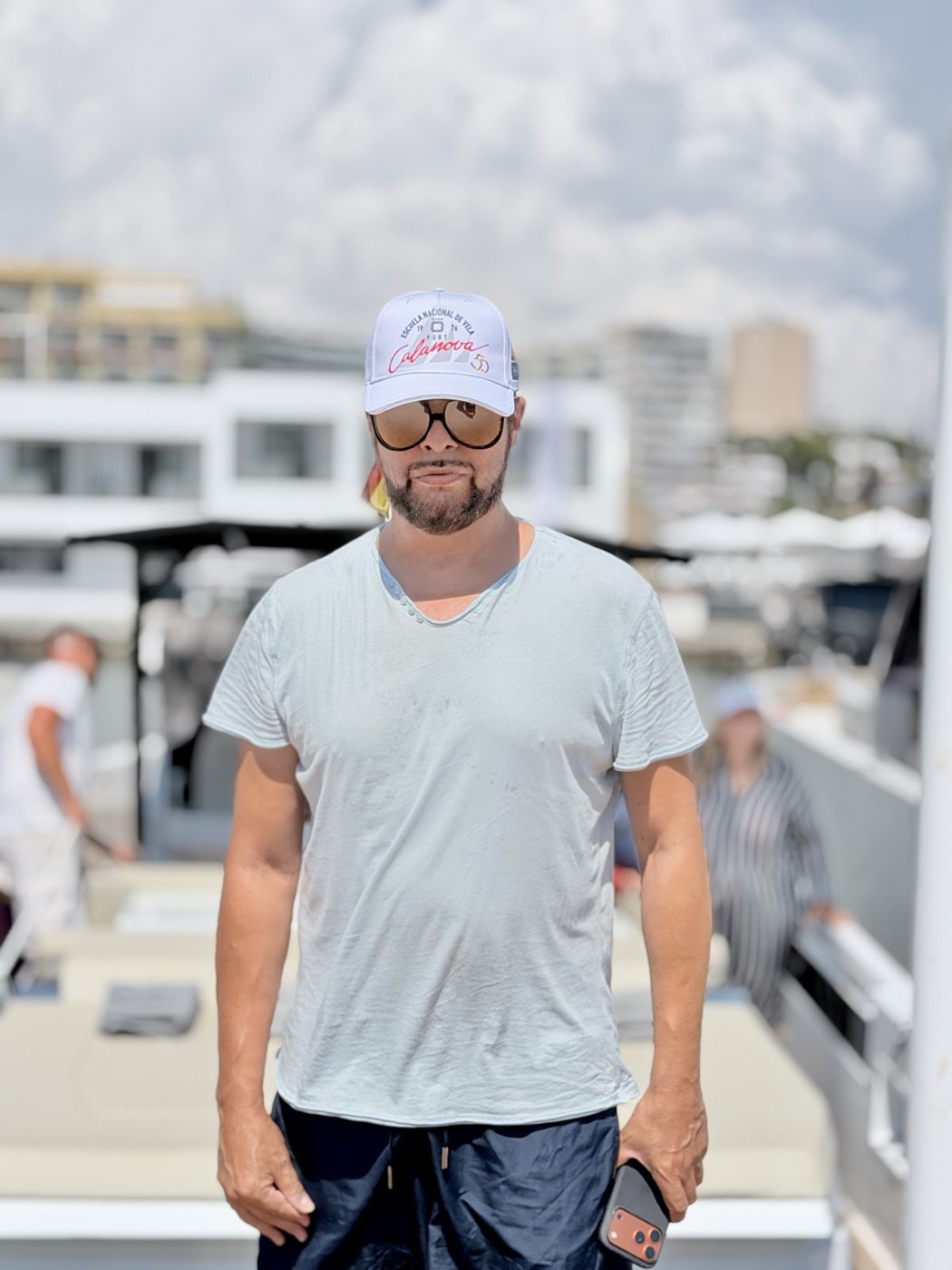 Joaquín Cortés at the marina, the harbour behind him